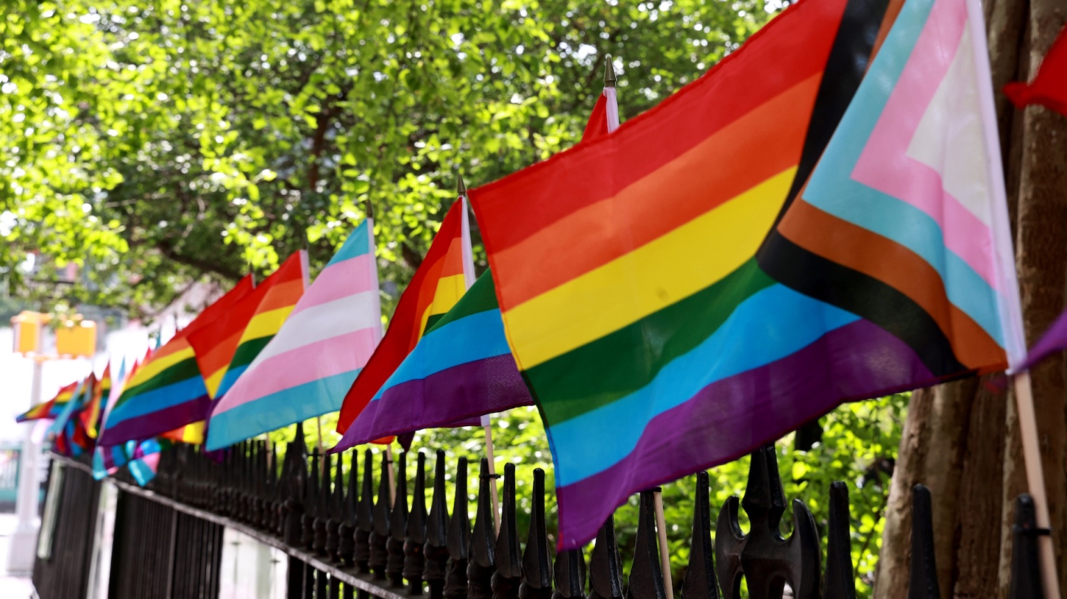 Pride flags on the fence at the Stonewall National Monument in Christopher Park, New York.