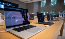 Numerous MacBook Pro laptops are on display in the Apple store on Kurfürstendamm