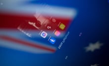 Social network logos display on a smartphone screen and the Australian flag appears on a computer screen in this photo illustration in Athens, Greece, on November 21, 2024. The Australian government proposes a ban on social media for all citizens under 16. Citing the success of recently introduced restrictions on mobile phones in Australian schools, the prime minister announces the ban by declaring that it is doing harm to children and he is calling time on it.