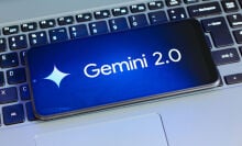 Google Gemini 2.0 logo on a smartphone thats sitting on top of a laptop keyboard