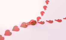 A zipper constructed of red hearts. At the opening of the zipper, the hearts become broken. 