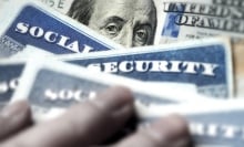 Money overlaid by Social Security cards.