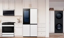 a kitchen and laundry room with samsung appliances and white cabinetry