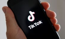 a hand hold a smartphone with the tiktok logo on it 