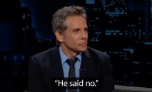 A man in a suit sits on a talk show sofa, smiling. The caption at the bottom reads "He said no."