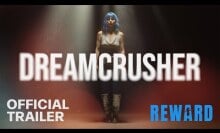 A woman in a blue wig behind the text "Dreamcrusher."