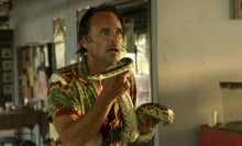 Walton Goggins as Rick in "The White Lotus," holding a large python.