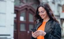 Person looking at phone smiling