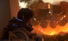 A close-up of a male character with shoulder-length dark hair and a futuristic armored suit, featuring glowing blue lights and intricate mechanical details. He gazes intently into the distance, with a determined expression. Behind him, a massive hovering machine looms over a fiery battlefield, with sparks and embers floating in the air. The scene is bathed in warm orange hues, contrasting with the cool tones of the character’s suit. The image is a high-quality, cinematic screenshot from a video game, captured on PS5, and developed by Kojima Productions.