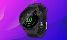 garmin forerunner 55 smartwatch against a pink and blue gradient background