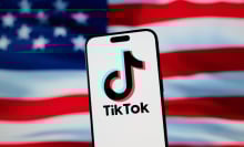the tiktok logo on a phone in front of the american flag