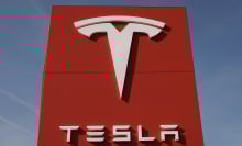 tesla logo on a big red sign