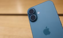 an iphone with a wood table in the background