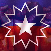 The dark red, blue and white Juneteenth flag overlaid with raised fists
