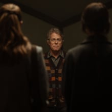 Sophie Thatcher and Chloe East stand together in front of Hugh Grant in the film "Heretic."