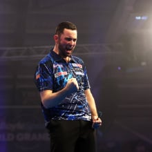 Luke Humphries of England celebrates victory
