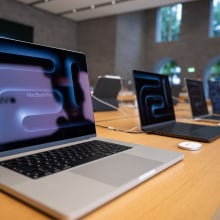Numerous MacBook Pro laptops are on display in the Apple store on Kurfürstendamm