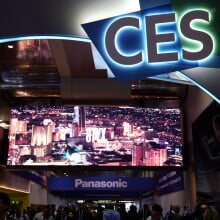 People walking on a conference center below a CES sign.