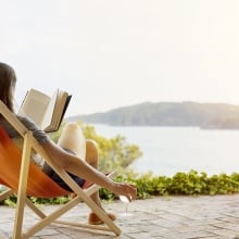 A woman relaxes and reads.