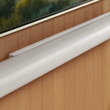 sonos arc ultra soundbar mounted on wood-paneled wall under tv screen