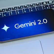 Google Gemini 2.0 logo on a smartphone thats sitting on top of a laptop keyboard