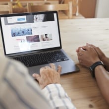 A doctor and patient consult a health website.