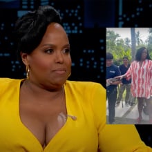 A woman sits on a talk show sofa. Beside her is another image of the same woman touching a lizard.