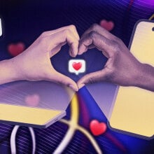 two hands reaching out of laptops to form a hand heart