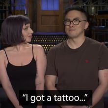 A man and a woman stand on a stage.