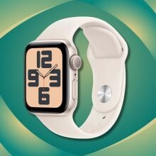 a starlight colored apple watch se 2 against a green and yellow patterned background