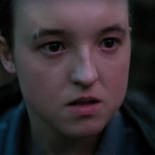 A close-up of a young woman's face looking angry.