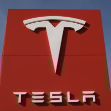 tesla logo on a big red sign