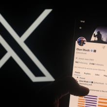 x logo next to a phone showing elon musk's x page