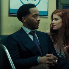 Lula (Kate Mara) offers an apple to Clay (André Holland) during an unexpected encounter on a New York subway train in this scene from "The Dutchman."