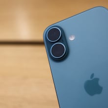 an iphone with a wood table in the background