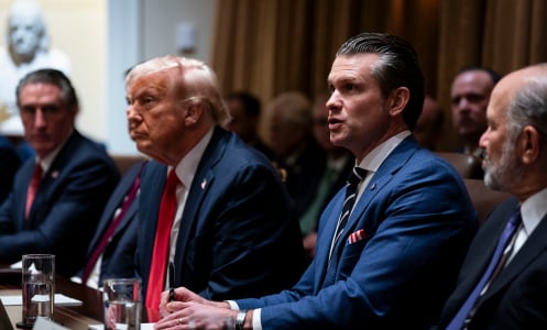 President Donald Trump and Defense Secretary Pete Hegseth sit at a table during a cabinet meeting.
