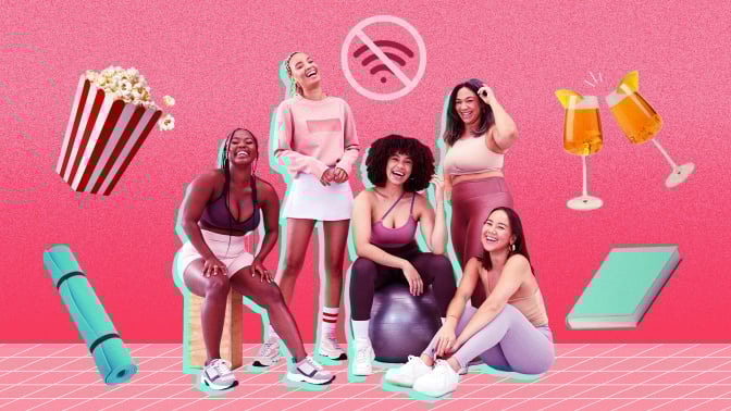 A group of women in workout clothes smiling and laughing surrounded by books, drinks, popcorn, and no wifi. 