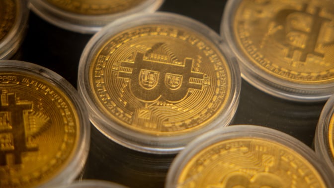 Gold coins with the Bitcoin "B" stamped on them.