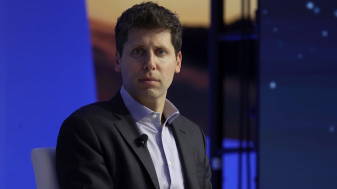 sam altman looking at the camera in suit