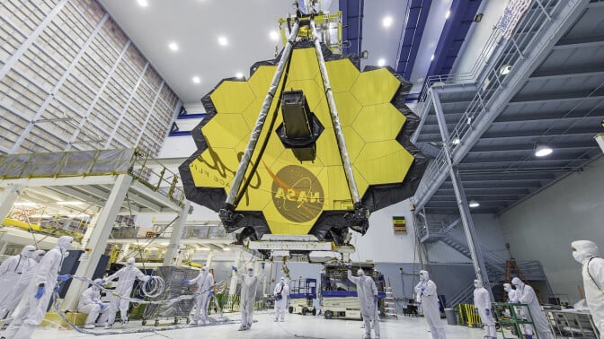 NASA technicians working on the James Webb Space Telescope's giant 18-segmented gold mirror.