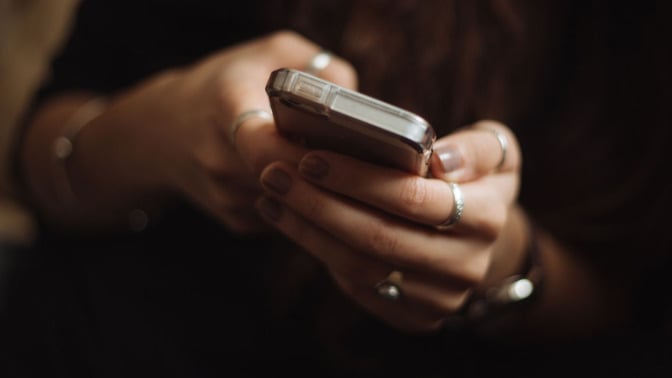 close-up of woman holding smartphone in her hands