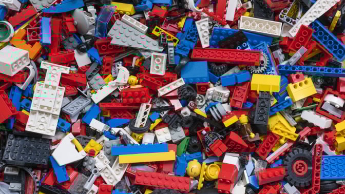 View from above into a box with many different colourful Lego bricks.