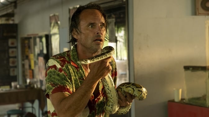 Walton Goggins as Rick in "The White Lotus," holding a large python.