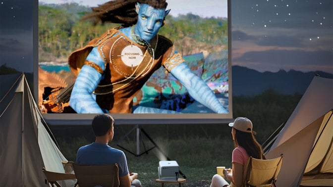 couple watching Portable Projector with avatar 2 on screen