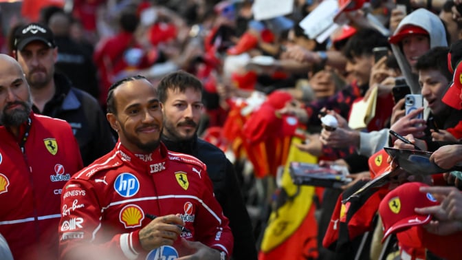 British F1 driver Lewis Hamilton signs autographs