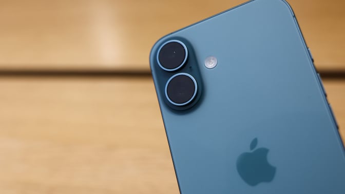 an iphone with a wood table in the background