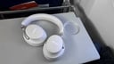 white smoke bose headphones on airplane tray table