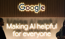The Google logo on a wall, above the slogan "Making AI helpful for everyone."