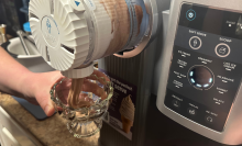 A person dispensing soft serve from a Ninja Swirl