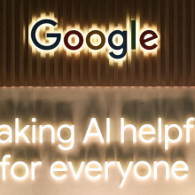 The Google logo on a wall, above the slogan "Making AI helpful for everyone."